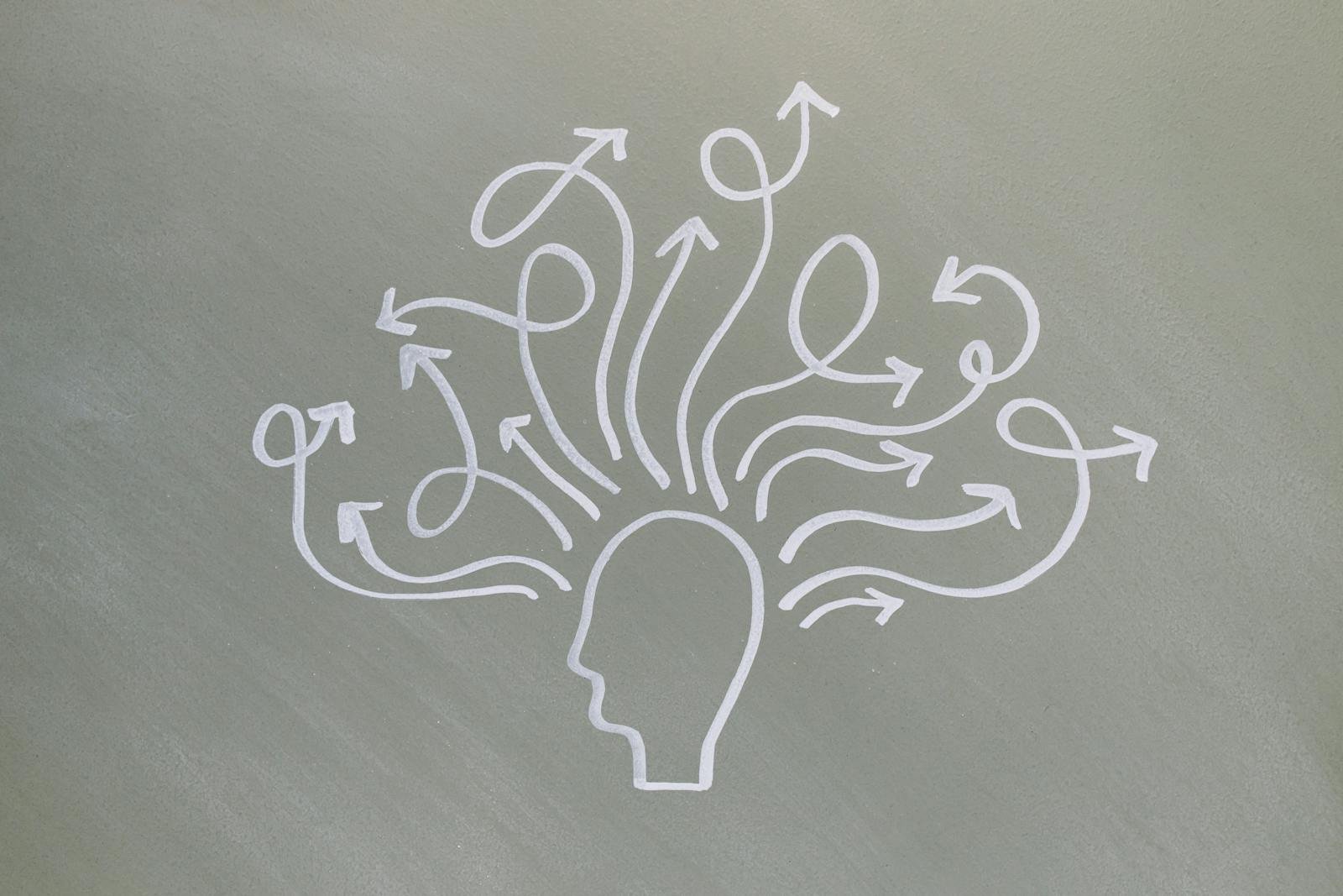 Conceptual chalk drawing illustrating mental health challenges with arrows representing thoughts.